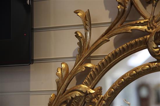 A Victorian oval gilt wall mirror, 4ft 11in. x 2ft 9.5in.